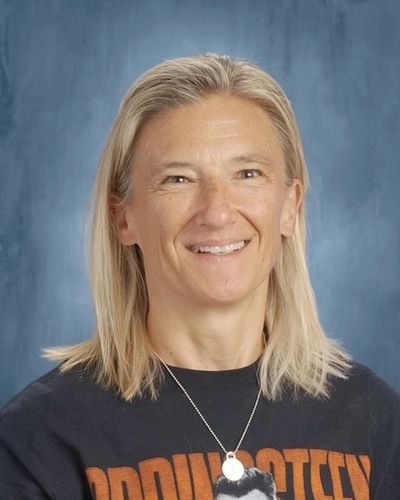 Smiling woman with blonde hair wearing a black shirt.
