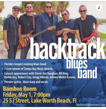 Backtrack Blues Band posing with guitars outdoors.