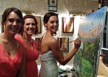 Bride and Bridesmaids add to a wedding  painting.
