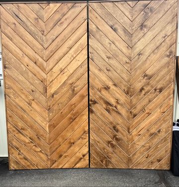 Chevron pattern, stained wood backdrop. Used for wedding decor