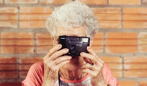 An eldery lady taking a photograph