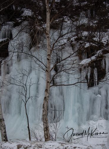 Cascading water frozen in time creating an ice wall. 