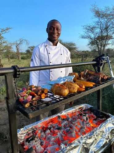 Chef at BBQ for safari camp in Serengeti