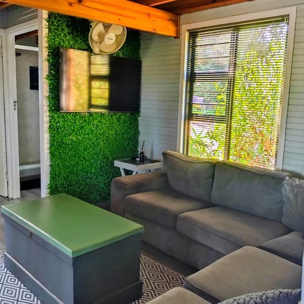 Cozy living room with green accents and natural light.