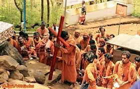 Why wearing saffron robes of Hindu monks but carrying a Cross? Why wearing saffron robes of Hindu monks but carrying a Cross?