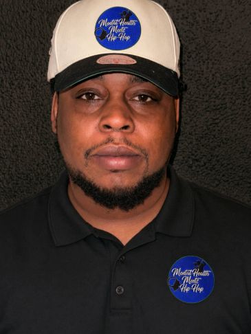 Man wearing hat and shirt with Mental Health meets Hip Hop logo.