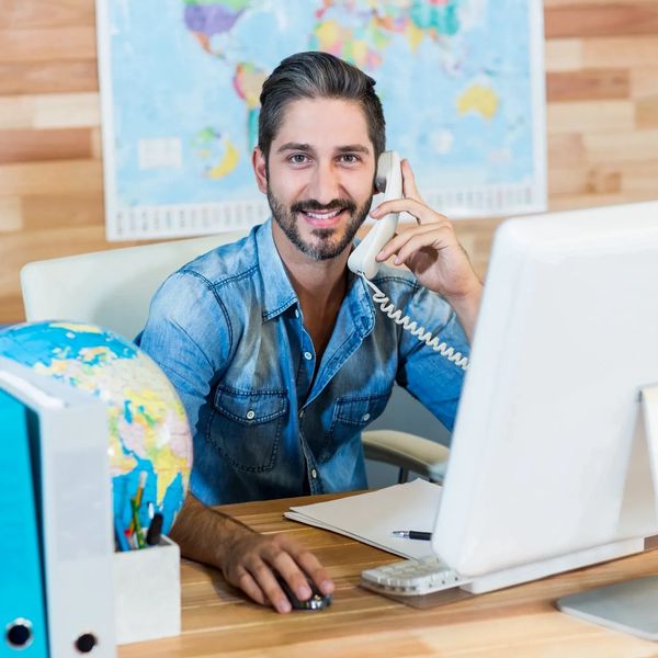 Man holding a phone and smiling.