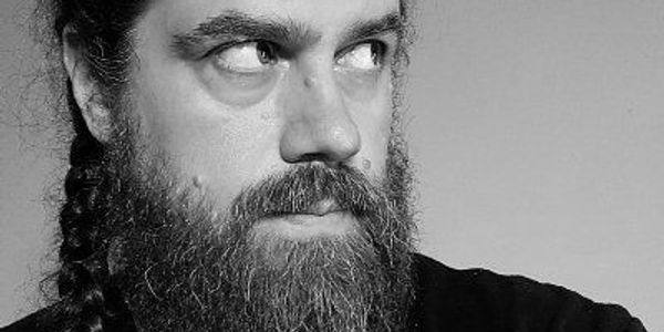 Black and white portrait of a bearded man looking to the side.