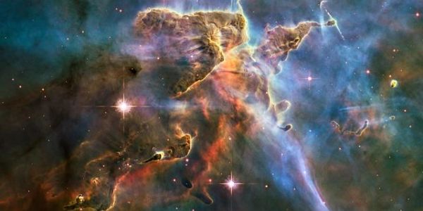 Colorful cosmic nebula with stars and gas clouds.