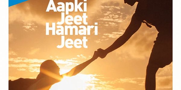 Helping hand reaching out at sunset with Hindi text.
