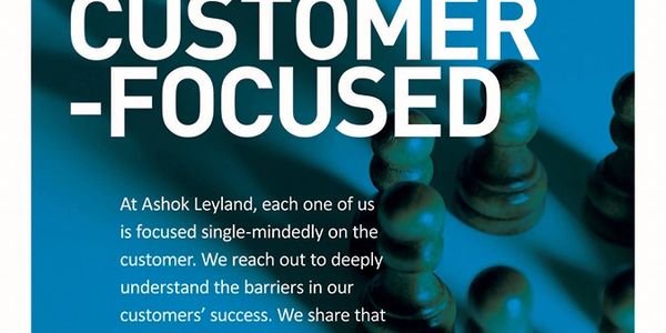 Customer-focused message from Ashok Leyland with chess pieces in background.