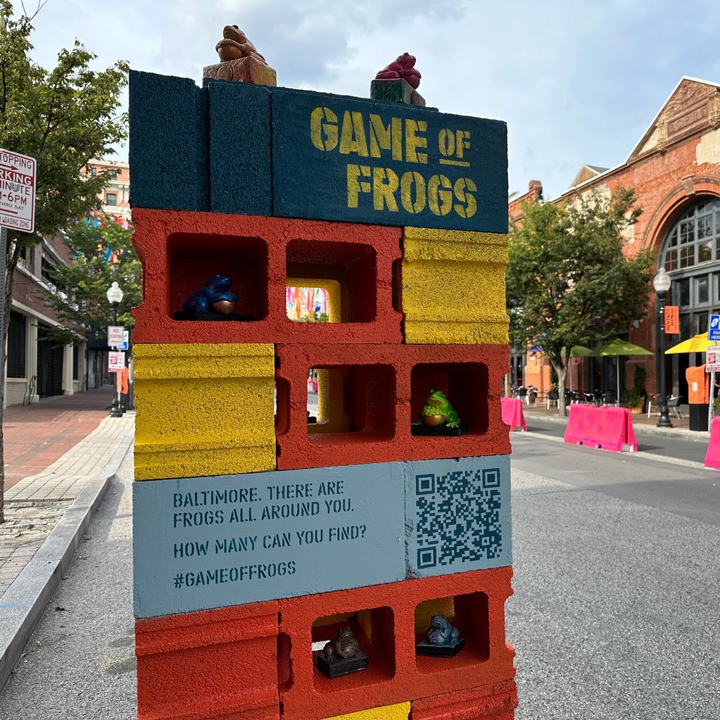 Colorful block sculpture with frog figurines and text Game of Frogs.