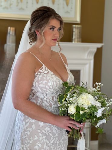 low bun with softness around the face to make the hairstyle look romantic  