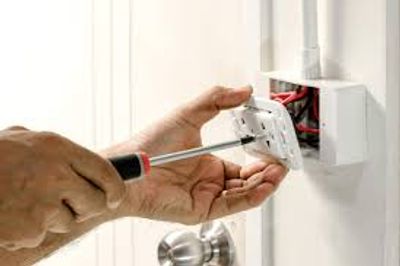 Electrician changing out duplex receptacle. 