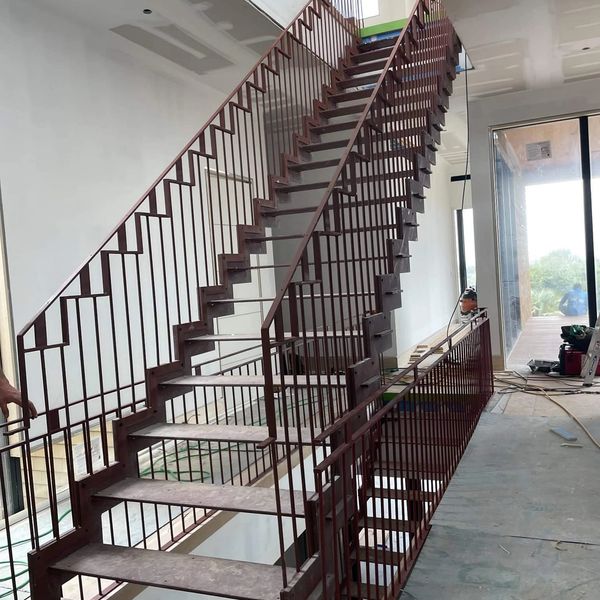 Monobeam stair with specialty vertical rails & metal rail cap