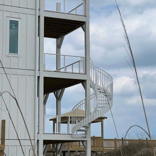 Carolina Curve staircase with cable rails on the second, third and fourth level landings
