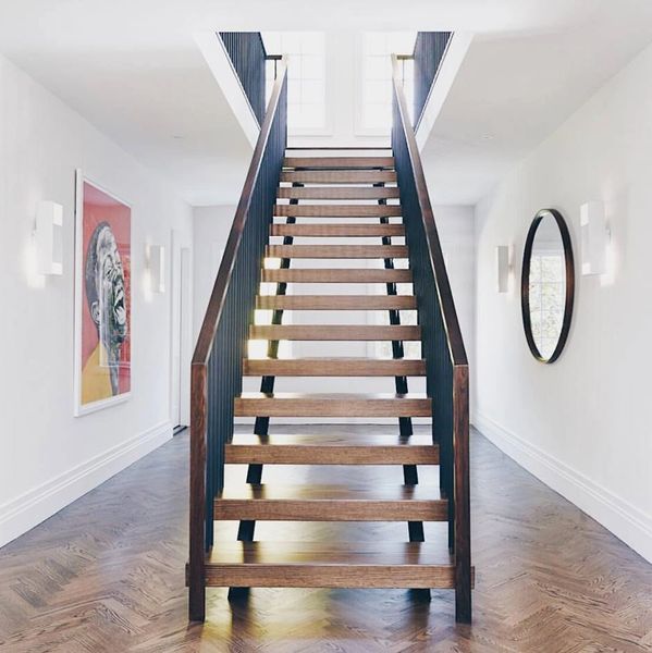 Monobeam stair with vertical rail pickets and custom wood rail cap