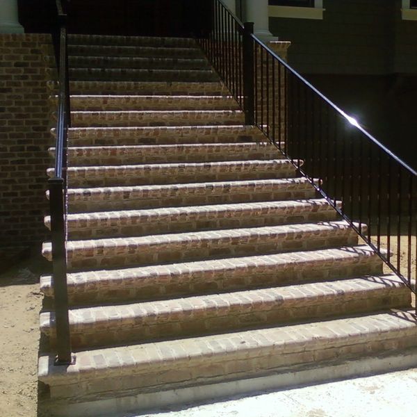 Outdoor stair railing with vertical pickets. Powder coated black