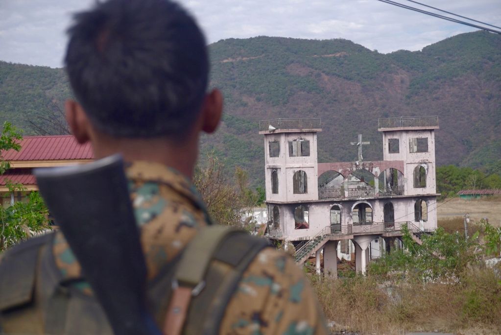 CNA soldier looking back at the Church from the post they have seized in the previous week in Januar