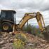A backhoe is digging during a perc test. 