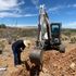 A civil engineer is measuring how deep the percolation test hole is. 
