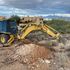 A backhoe is pictured digging a hole for a perc test.