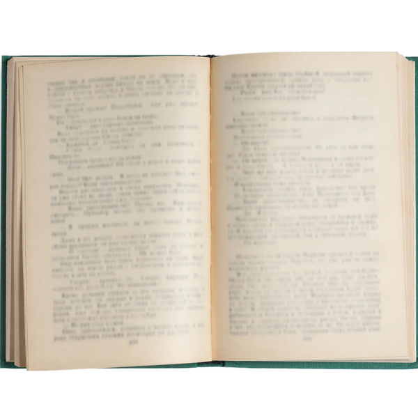 An open vintage book with slightly yellowed pages and blurred text.