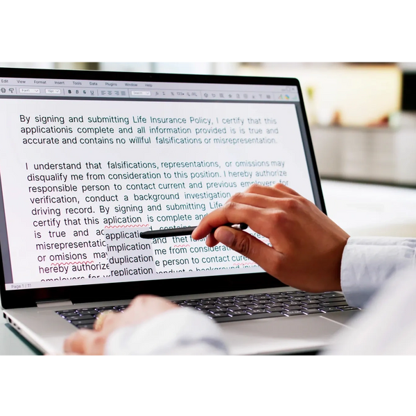 Person reviewing and editing a life insurance policy document on a laptop.