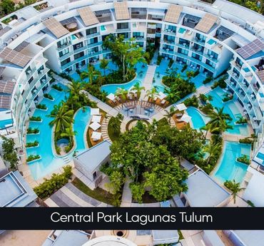 Aerial view of Central Park Lagunas Tulum with circular pool and surrounding buildings.