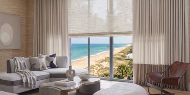 Elegant living room with ocean view and neutral decor.