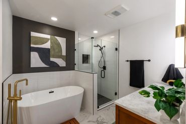 Modern bathroom with a freestanding tub and glass shower.