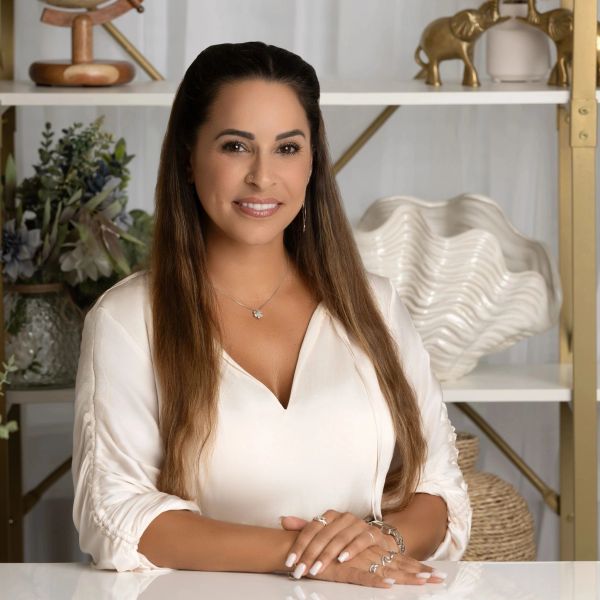 Woman sitting at a table smiling.