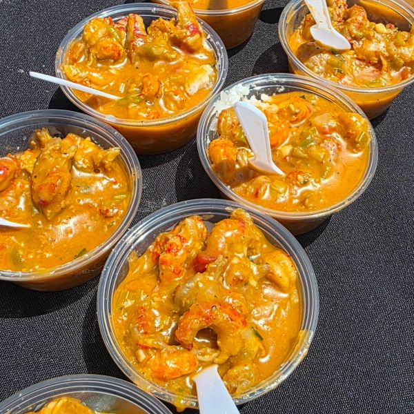 Cups of shrimp and seafood gumbo with spoons.