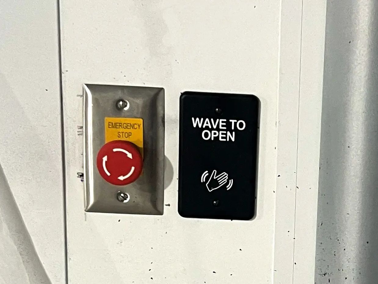 wave to open button on a wall