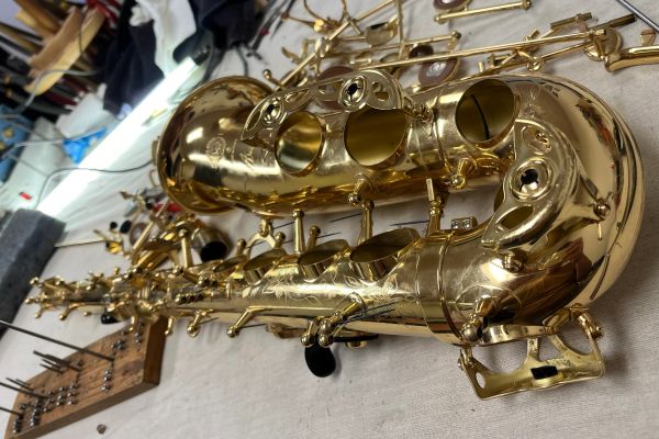 Close-up of a saxophone on a table.
