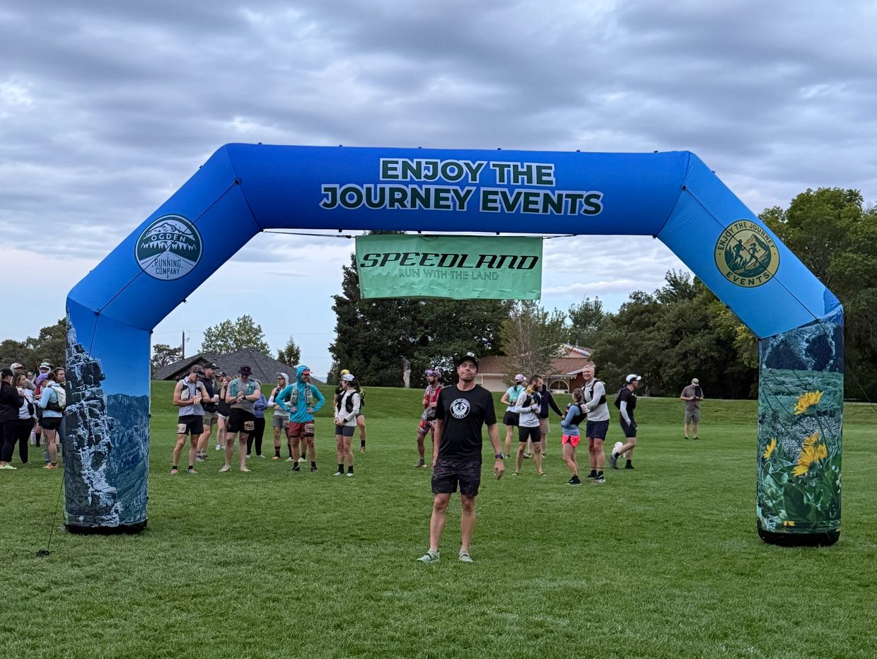 Runners gather under an arch for the Enjoy The Journey Speedland event.