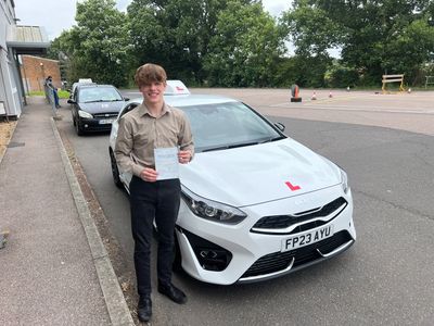 Young man showing his driving test certificate after a practical driving test