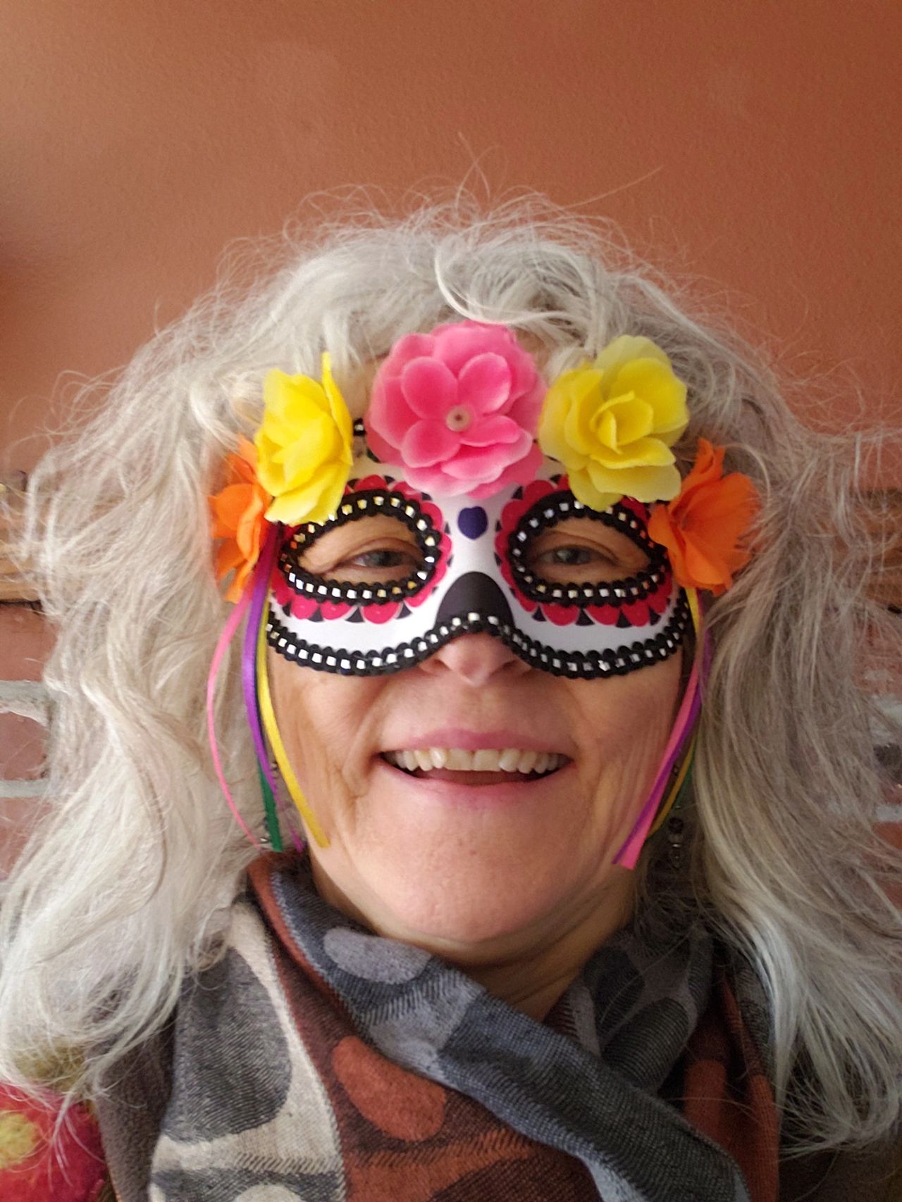 woman's face with Dia de los Muertos mask