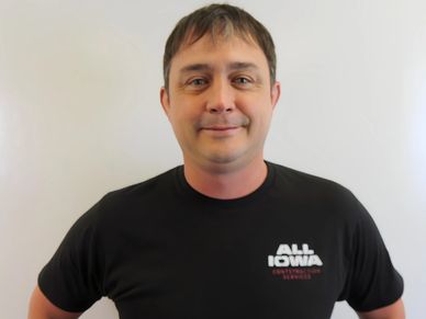 Man wearing a black t-shirt with 'All Iowa' text posing against a white background.