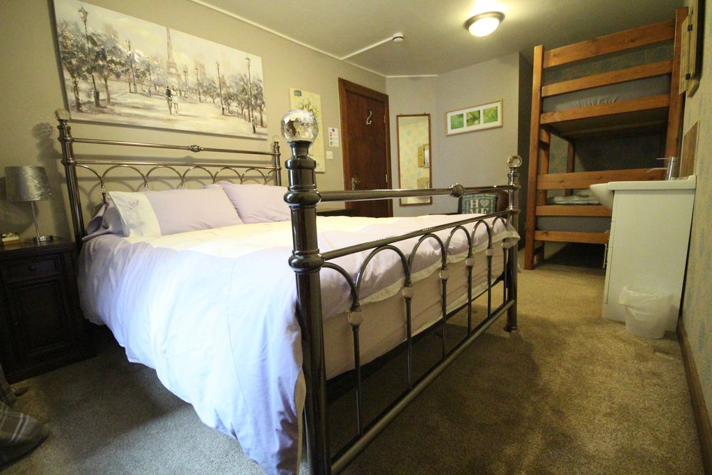 Family room with King size bed and a bunk bed.  Sleeps up to 4 people.