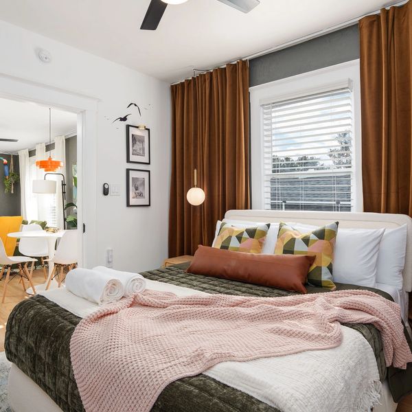 Primary bedroom with comfortable bedding. End your day in a calm space for a great night’s sleep.