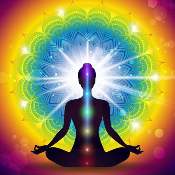 Silhouette meditating with colorful chakra lights and radiant mandala background.