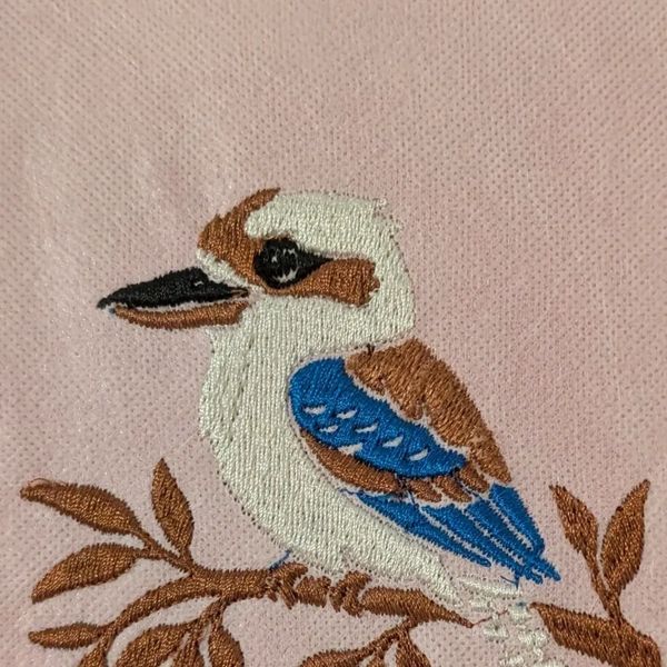 Embroidery of a bird on a branch.