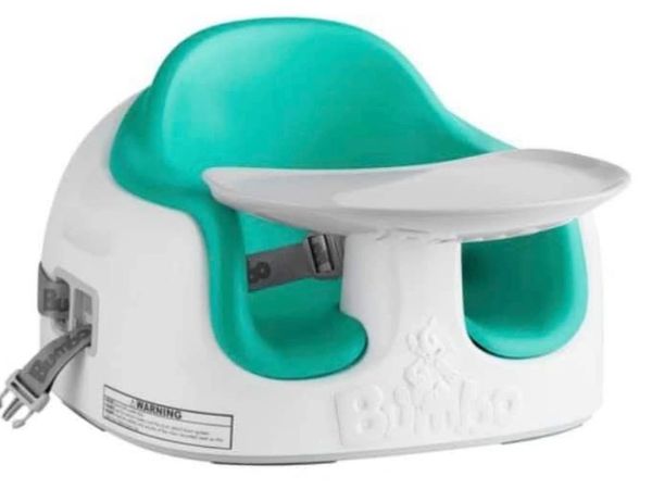 Green and white Bumbo booster seat.