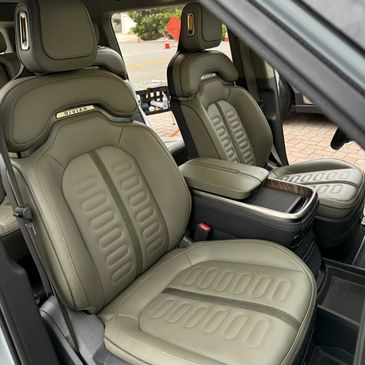 Luxurious green leather seats inside a Rivian vehicle.