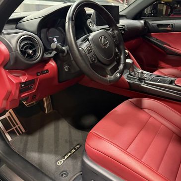 Luxurious red leather interior of a Lexus IS with sporty accents.