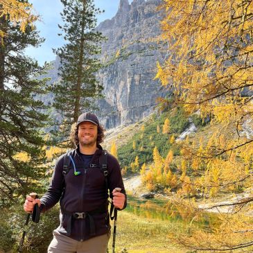 Man hiking in autumn mountainous forest.