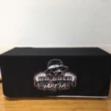 Black box with a Mafia-themed logo on a wooden surface.