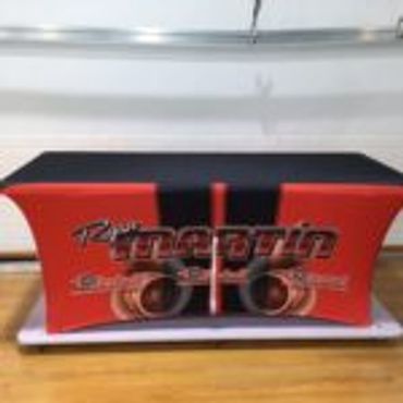 A red and black table cover with a graphic design and text.