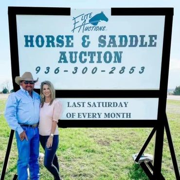 Don and Kandi Edwards posing by a sign for Elite Auctions Horse and Saddle Auction last Saturday